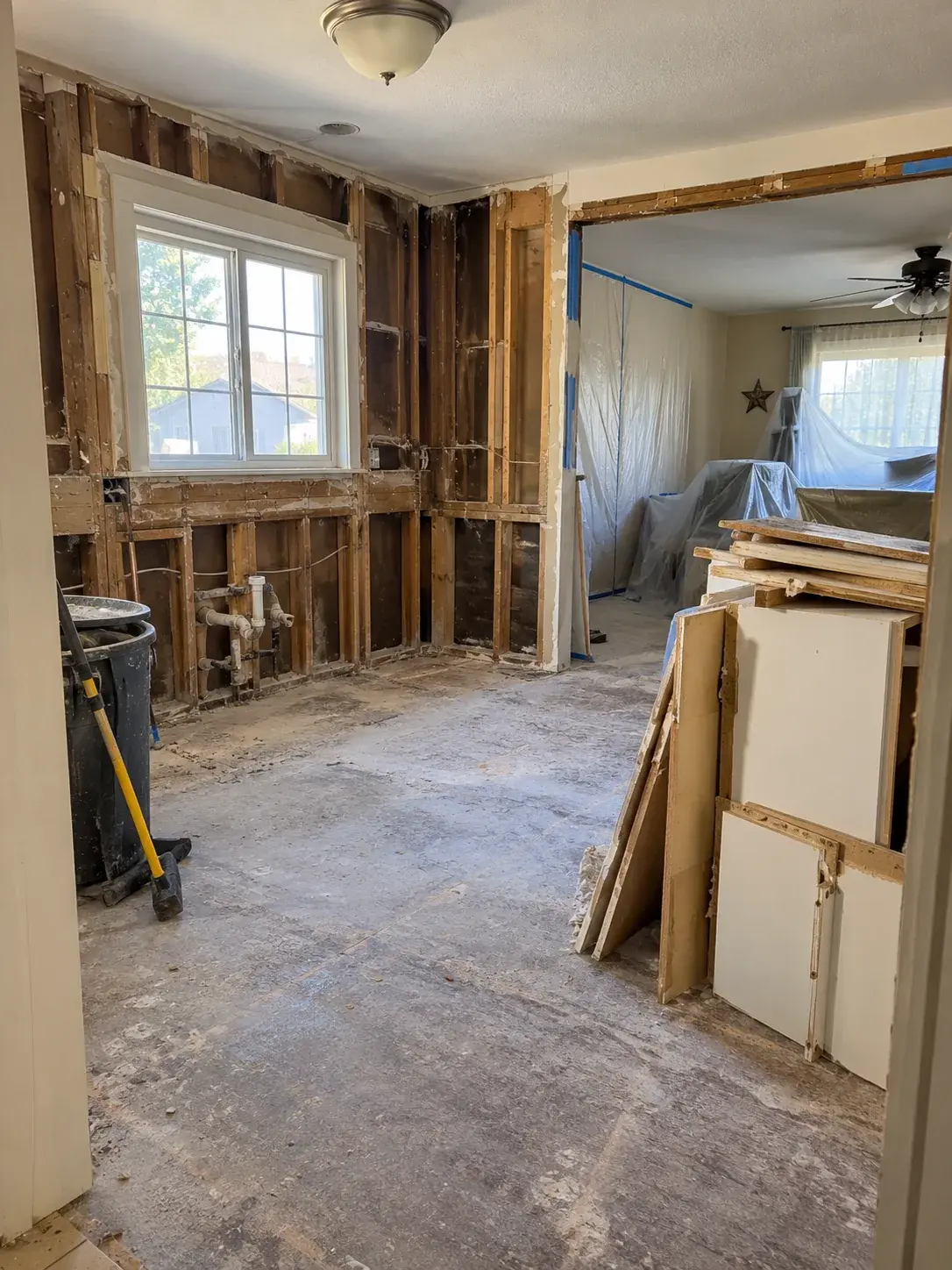 Residential kitchen and adjoining room prepared for remodeling
