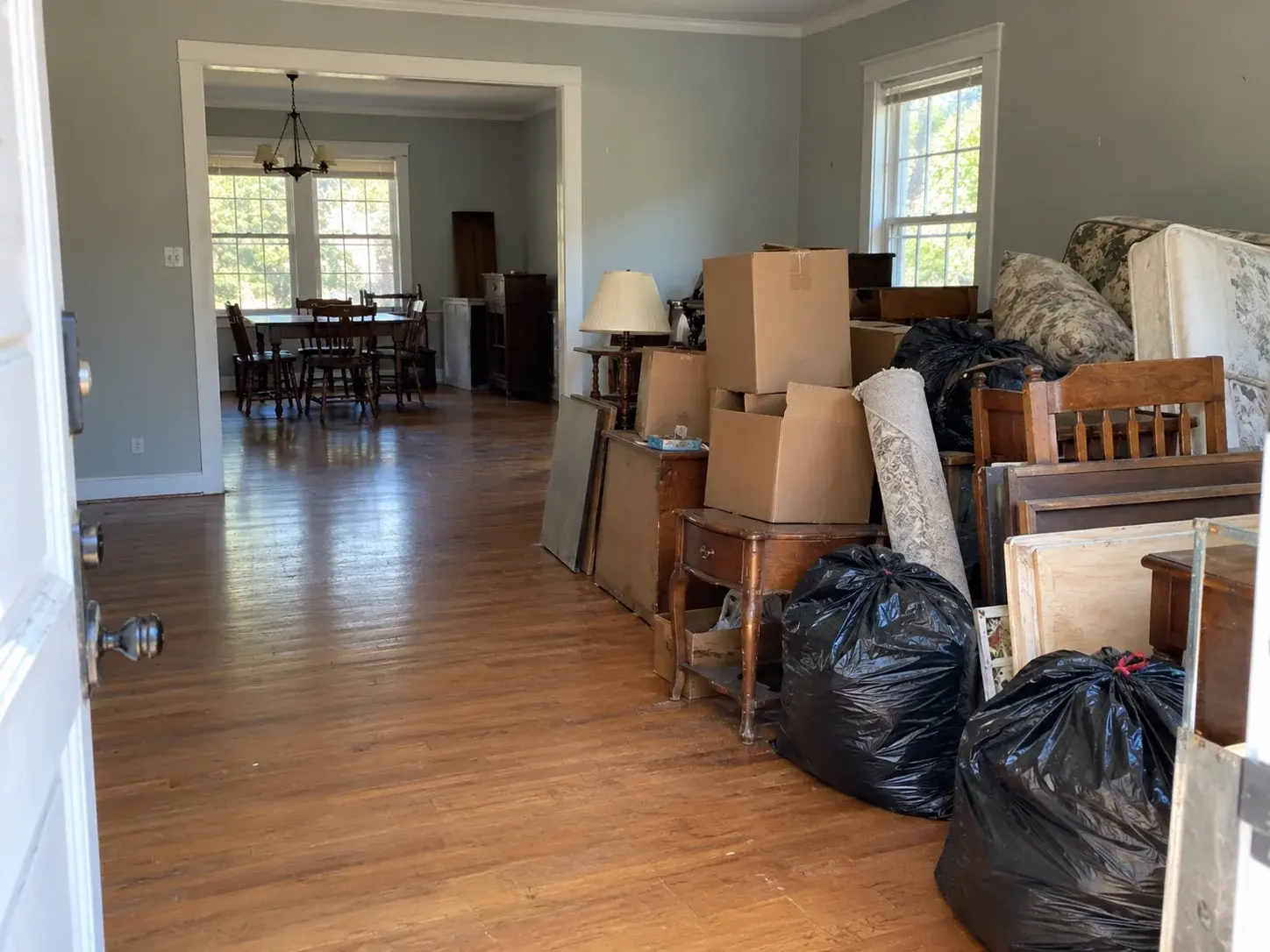 Furniture, boxes, and household contents staged during a whole-house cleanout